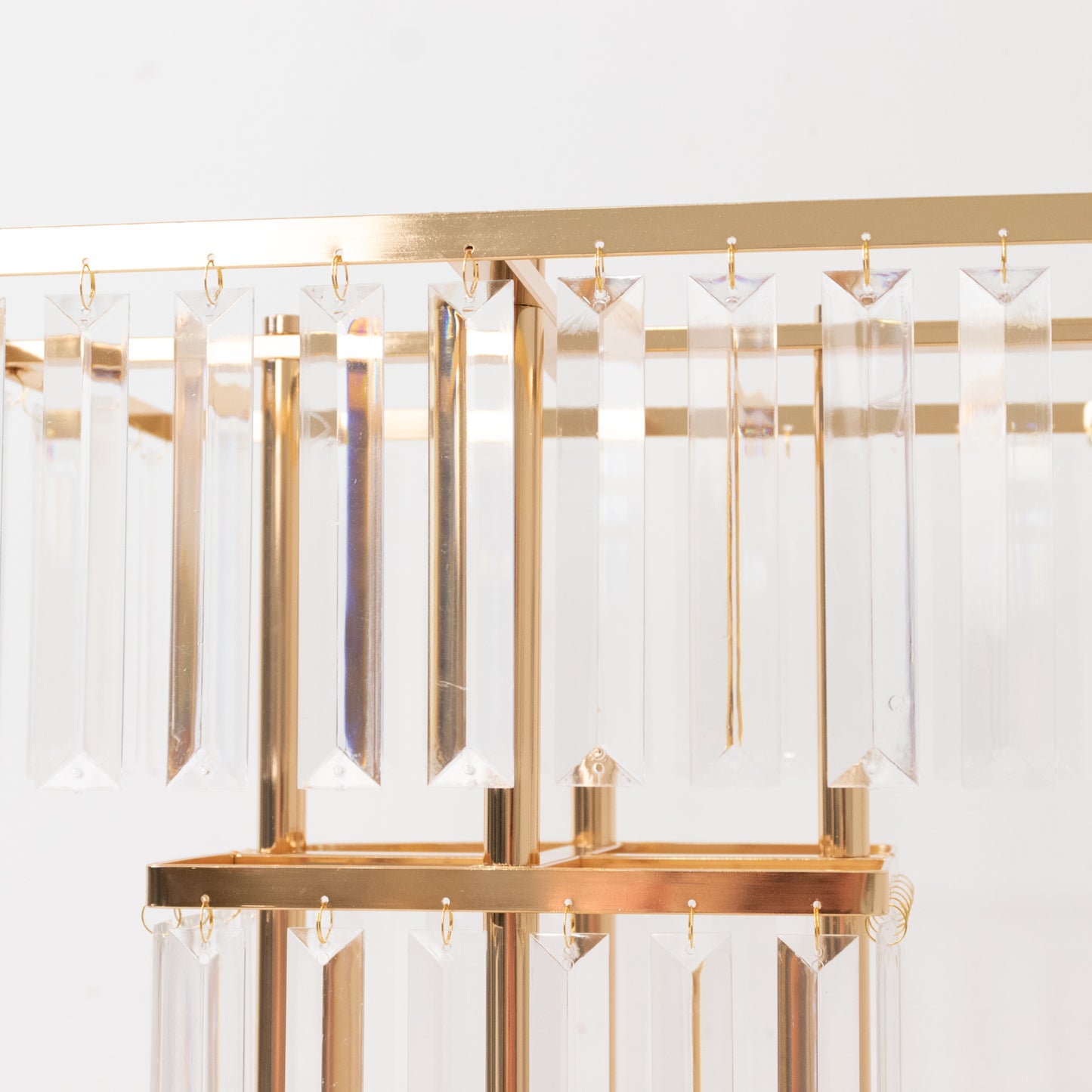 Gold crystal chandelier with hanging crystals and a modern design.