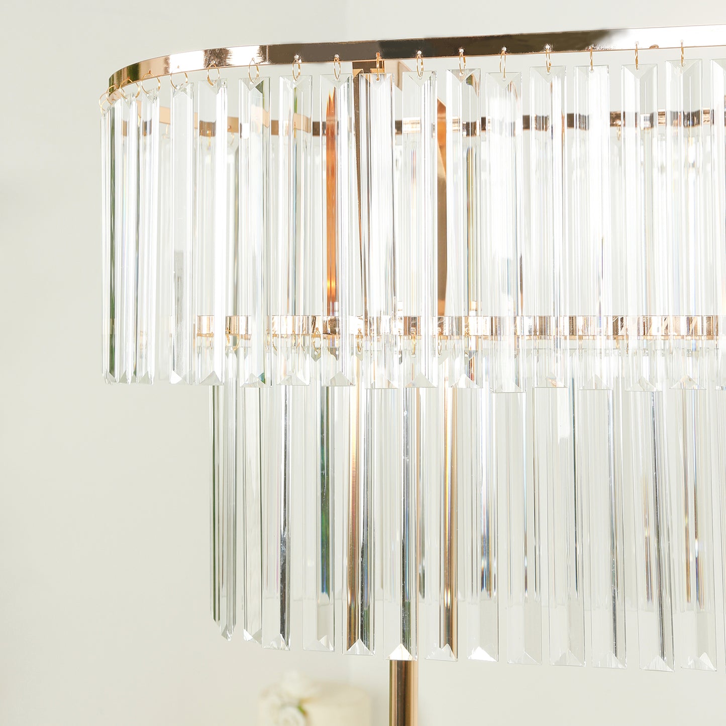 Gold crystal pendant flower stand centerpiece with tiered drop accents.