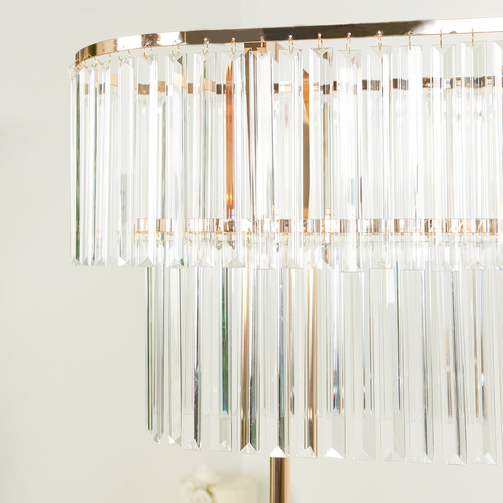 Gold crystal pendant flower stand centerpiece with tiered drop accents.