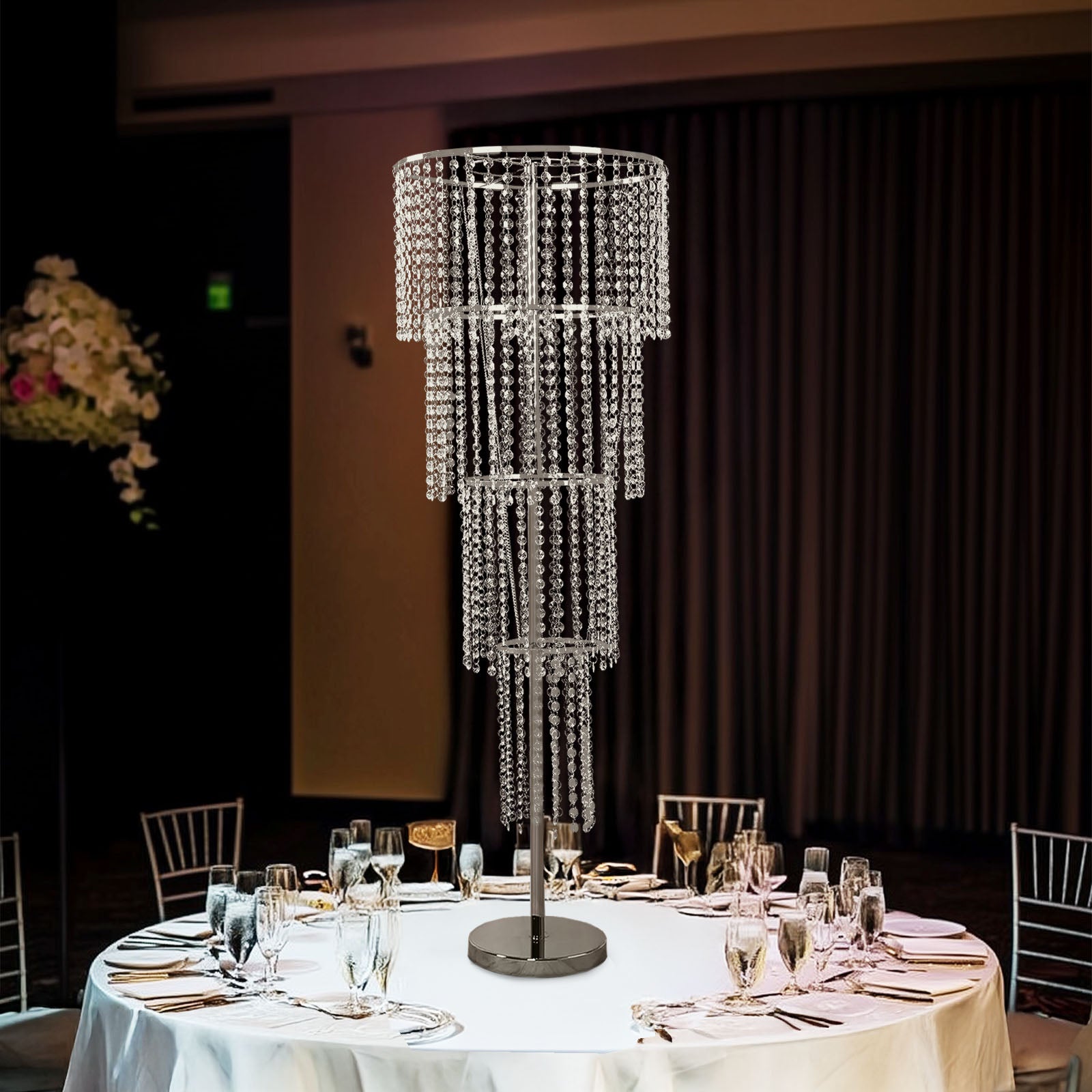 Clear acrylic beaded chandelier centerpiece for elegant wedding table decor.