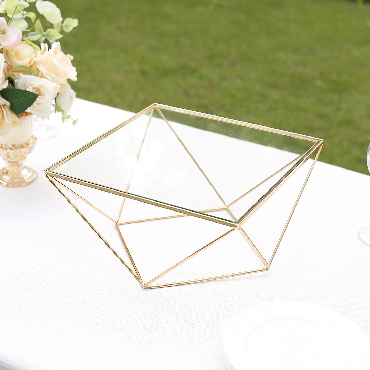 Gold geometric cake stand with square glass top centerpiece display.