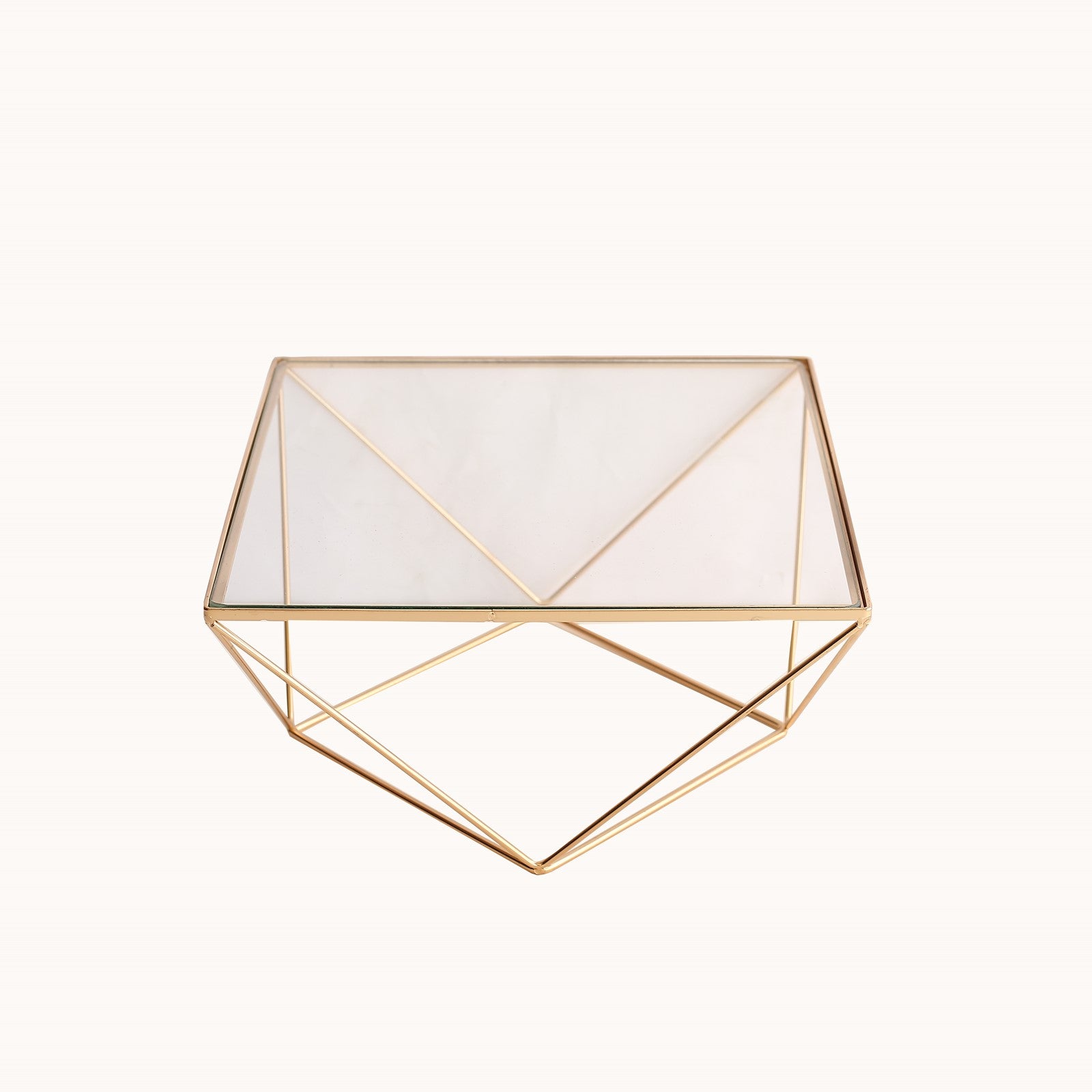 Gold metal geometric cake stand with square glass top.