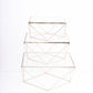 Gold geometric stackable cake stands with glass tops.
