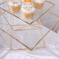 Gold metal geometric stackable cake stand pedestals with glass tops.