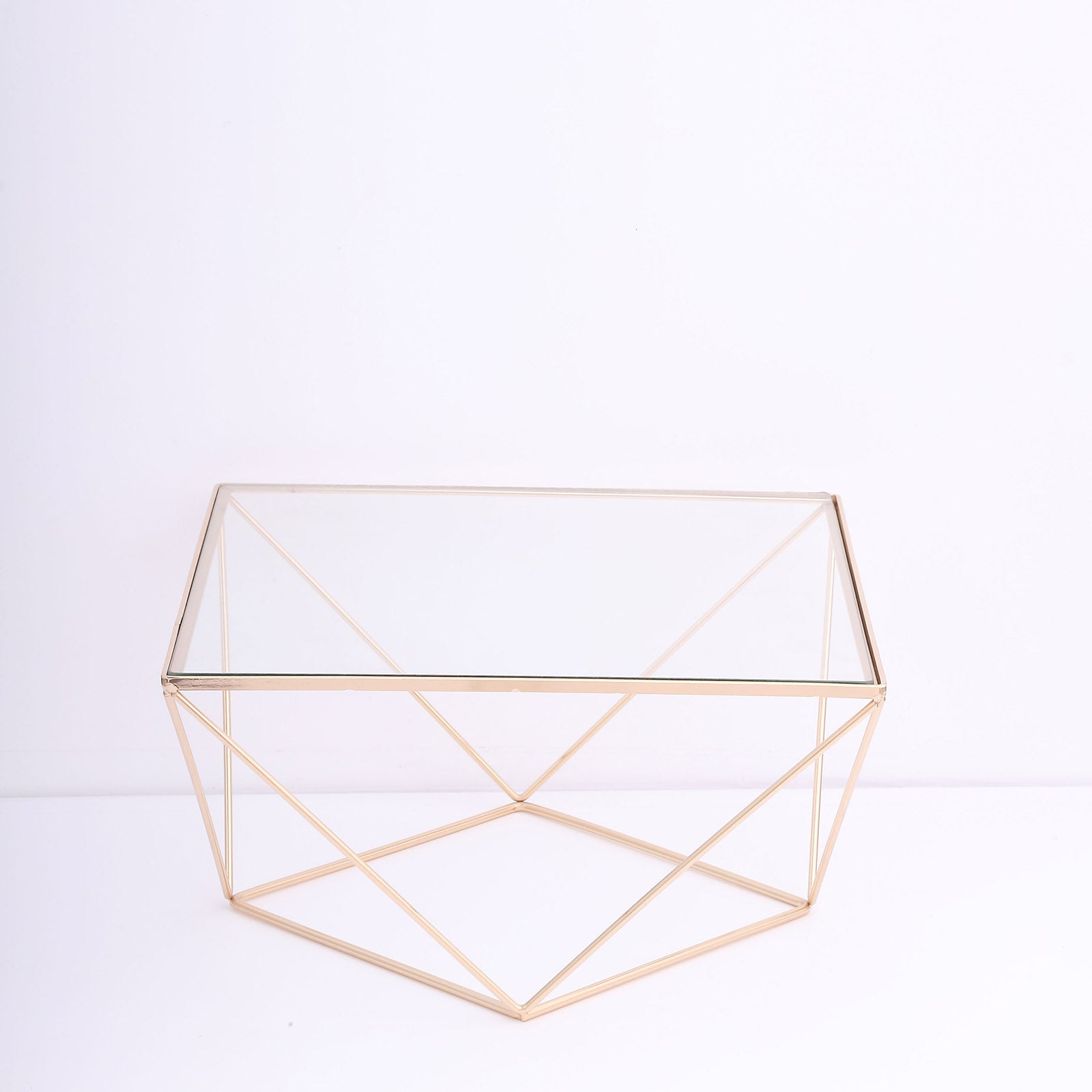 Gold metal geometric stackable dessert stand with square glass top.