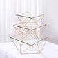 Gold metal geometric stackable cake stands with glass tops.