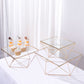 Gold metal geometric stackable cake dessert stands with glass tops.