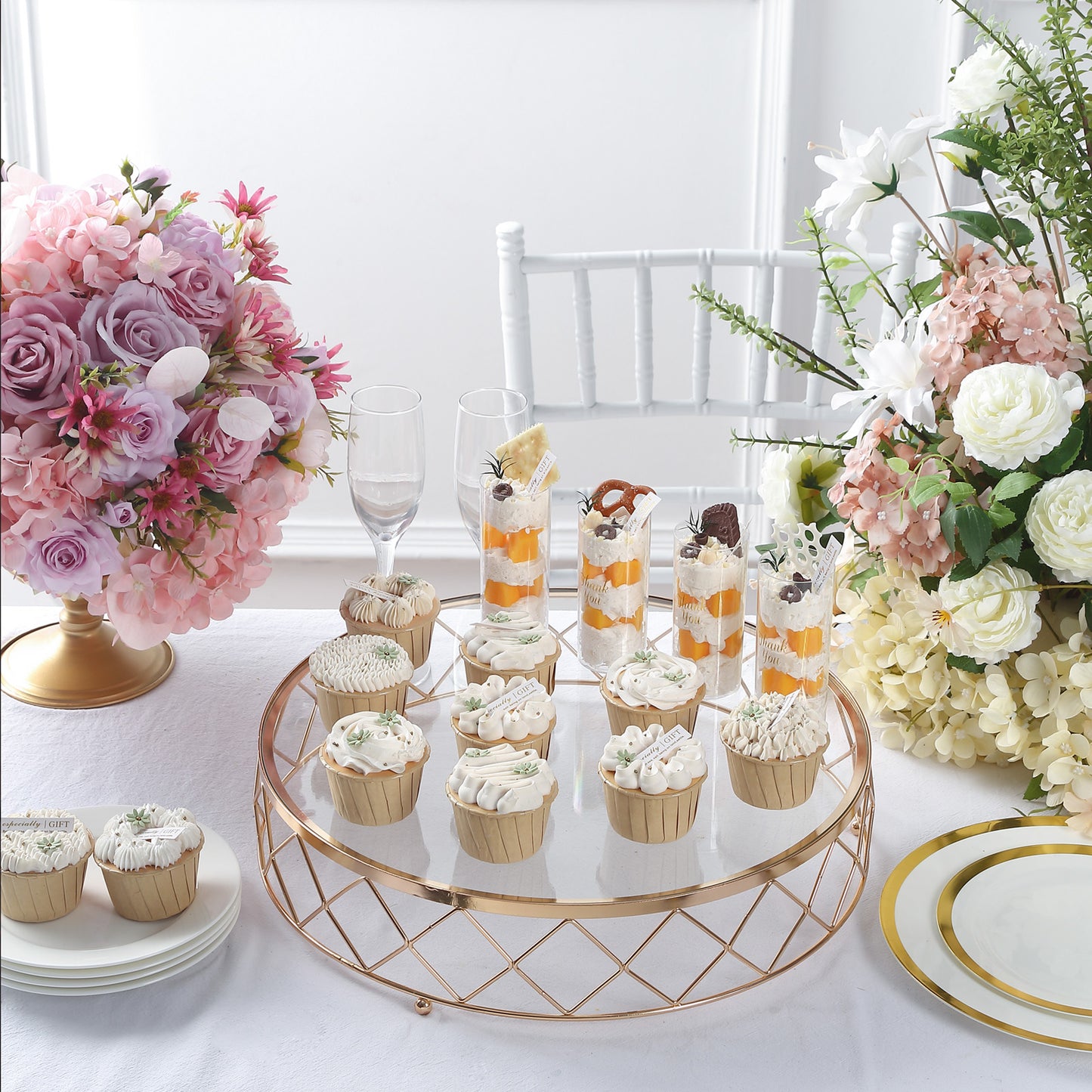 Gold geometric diamond cut cake stand with glass top displaying desserts.