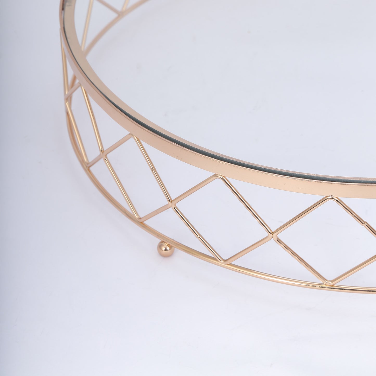 Gold geometric diamond cut cake stand with glass top.
