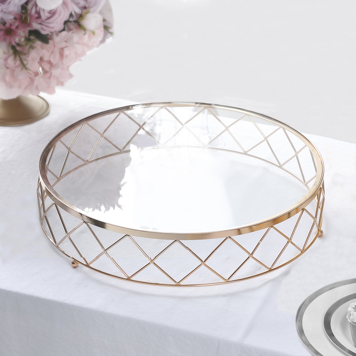 Gold geometric diamond cut cake stand with glass top.