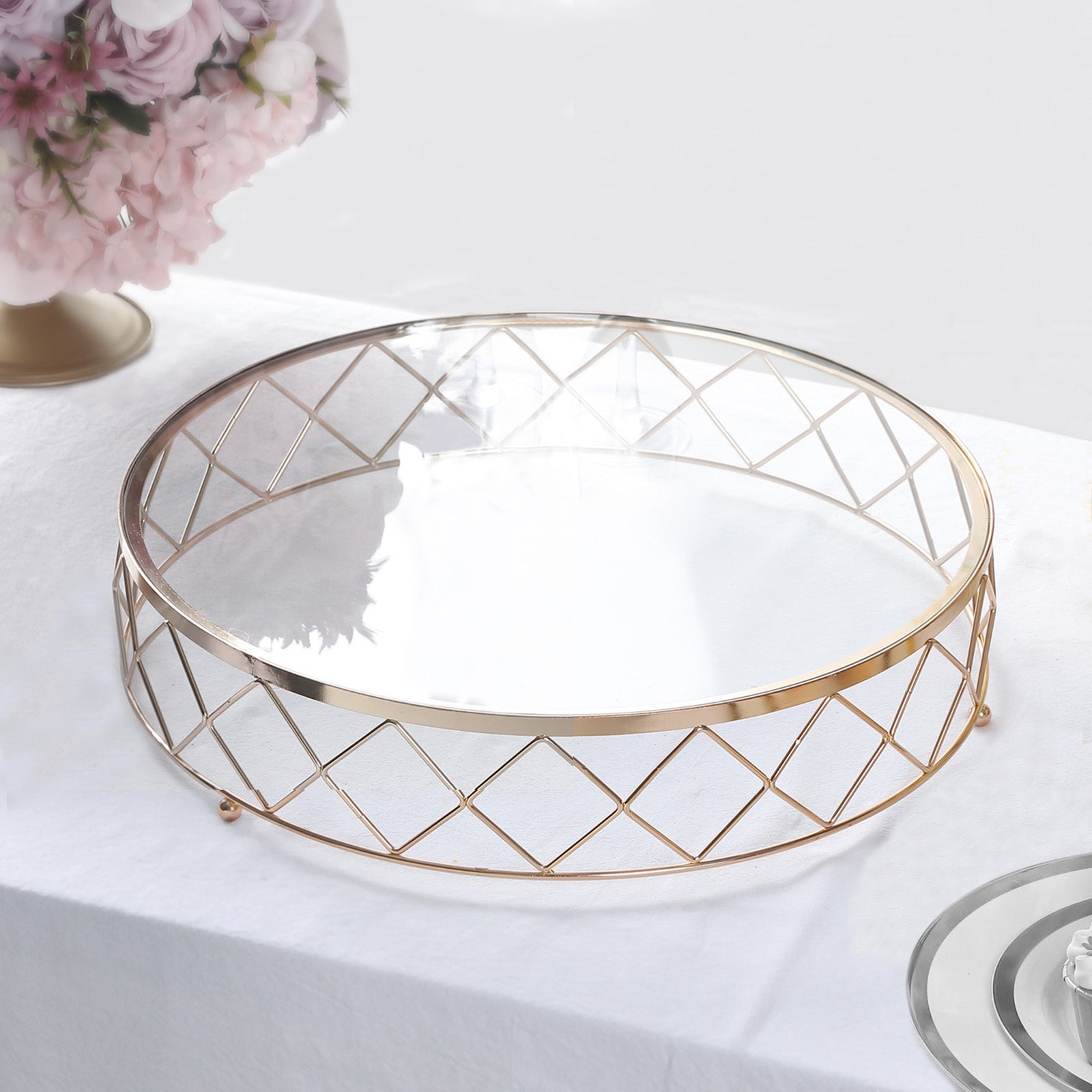 Gold geometric diamond cut cake stand with glass top.