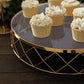 Gold geometric diamond cut cake stand with glass top displaying cupcakes.