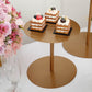 Gold metal round pedestal cupcake stands for dessert display.