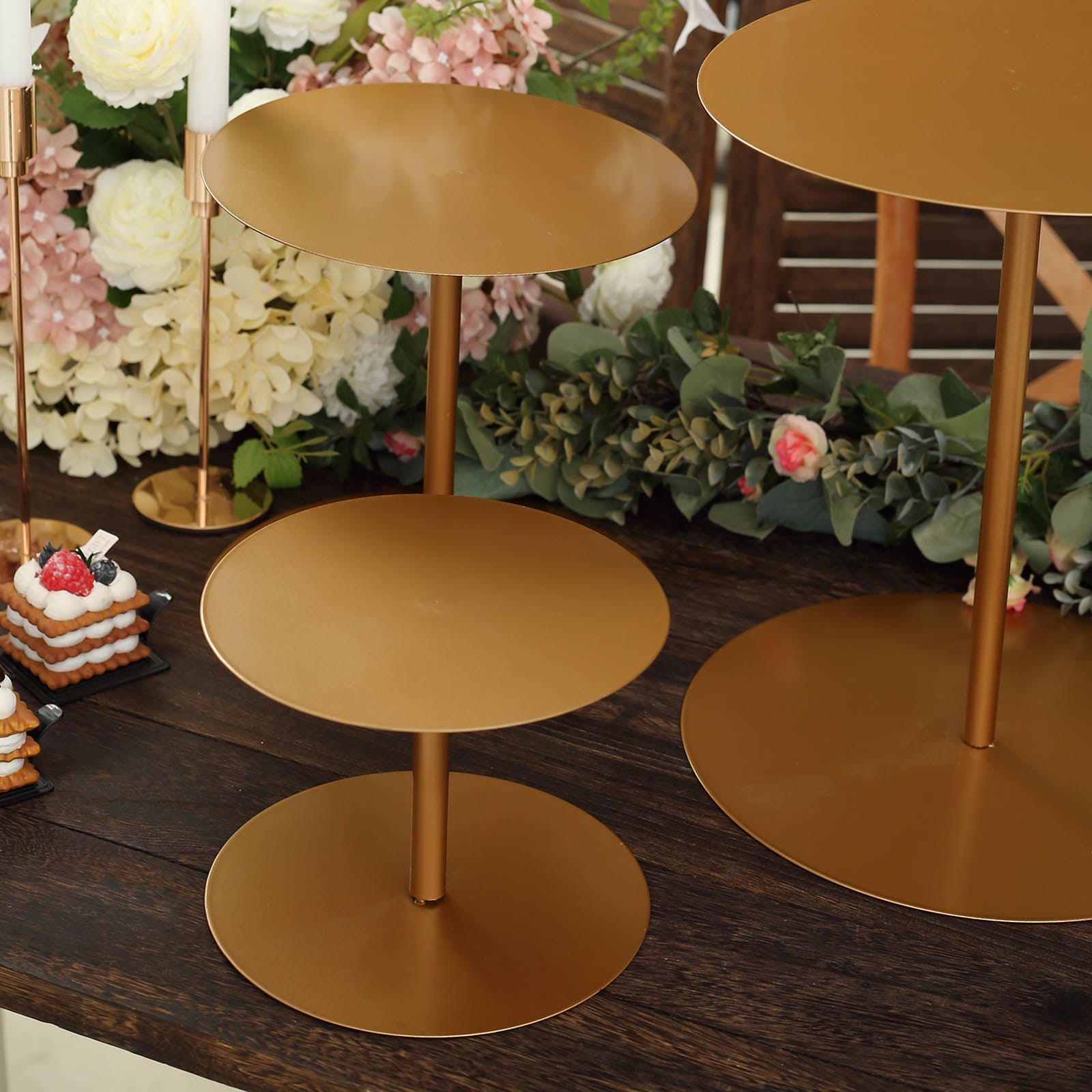 Gold metal round pedestal cupcake stands in three sizes.