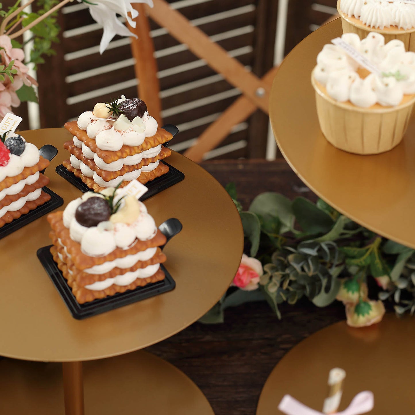 Gold metal round pedestal cupcake stands displaying desserts.