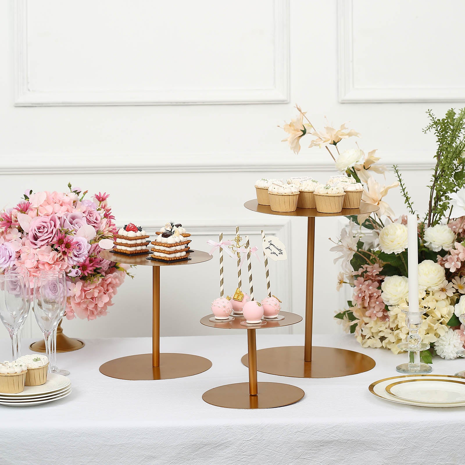 Gold metal round pedestal cupcake stands for dessert display.