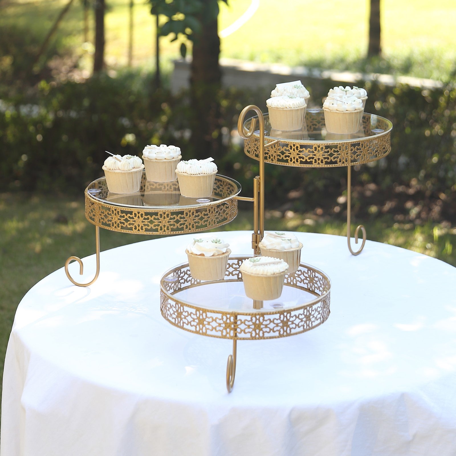 Gold metal 3-tier cupcake stand with clear acrylic plates and lace design.