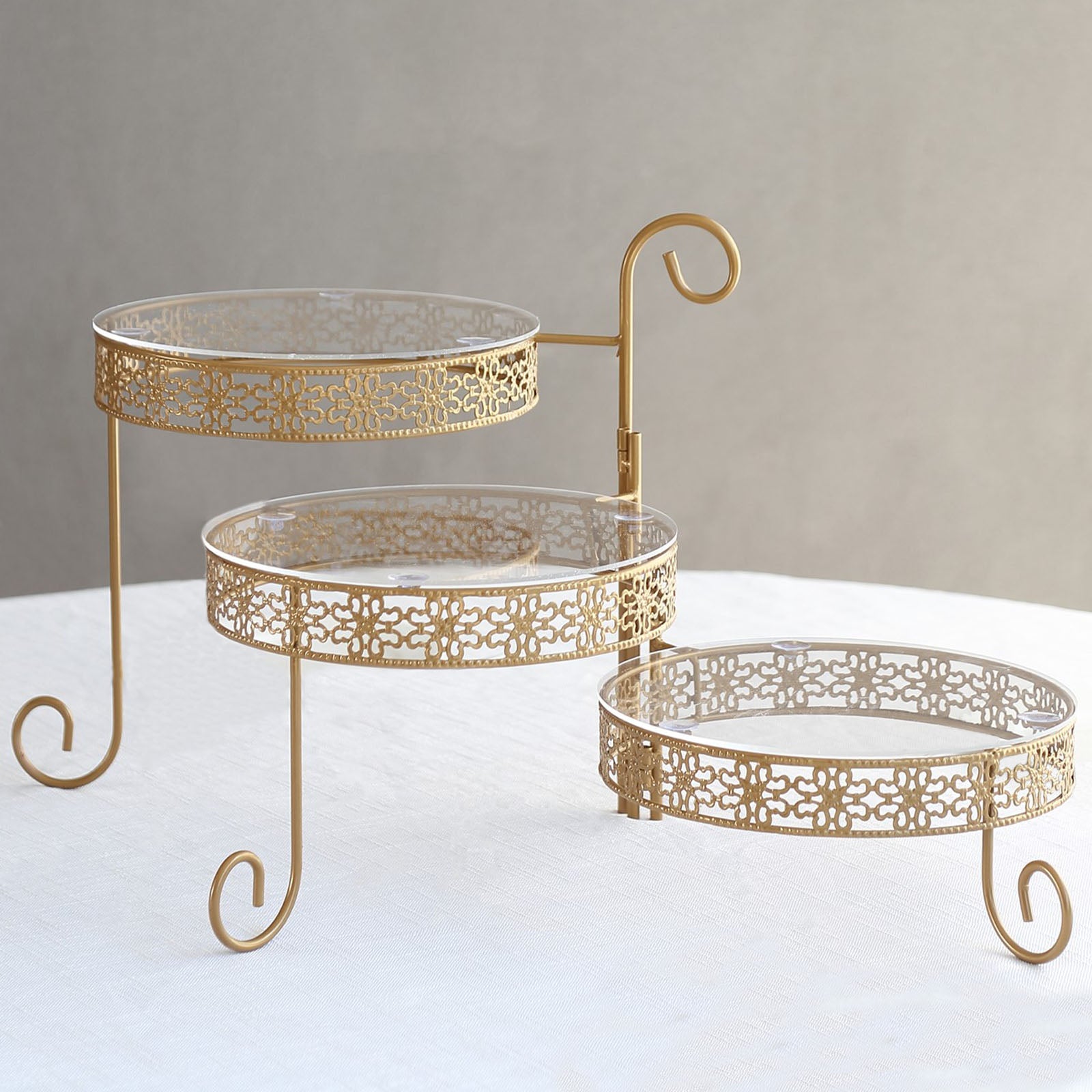Gold metal rotating cake stand with clear acrylic plates, 3-tier design.