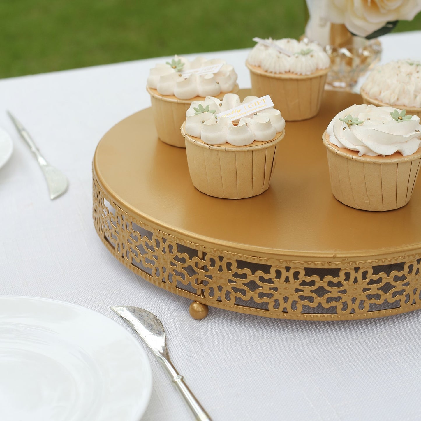 Gold metal pedestal cake stand with cupcakes, perfect for desserts and centerpieces.