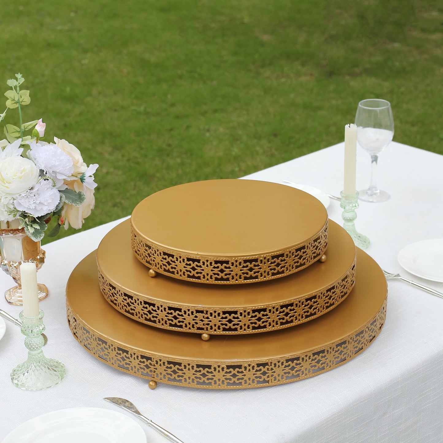 Gold metal fleur de lis cupcake display stand on a table centerpiece.