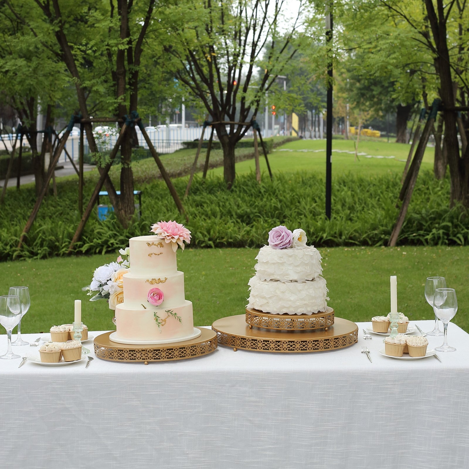 Gold metal fleur de lis cupcake stand with round pedestal centerpiece.