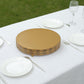 Gold metal cupcake display stand on a table with white plates.