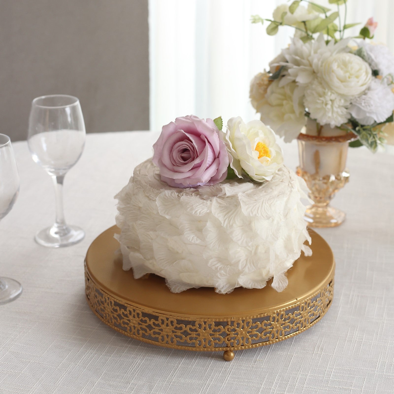Gold metal round pedestal cake stand with floral decor, perfect for desserts.