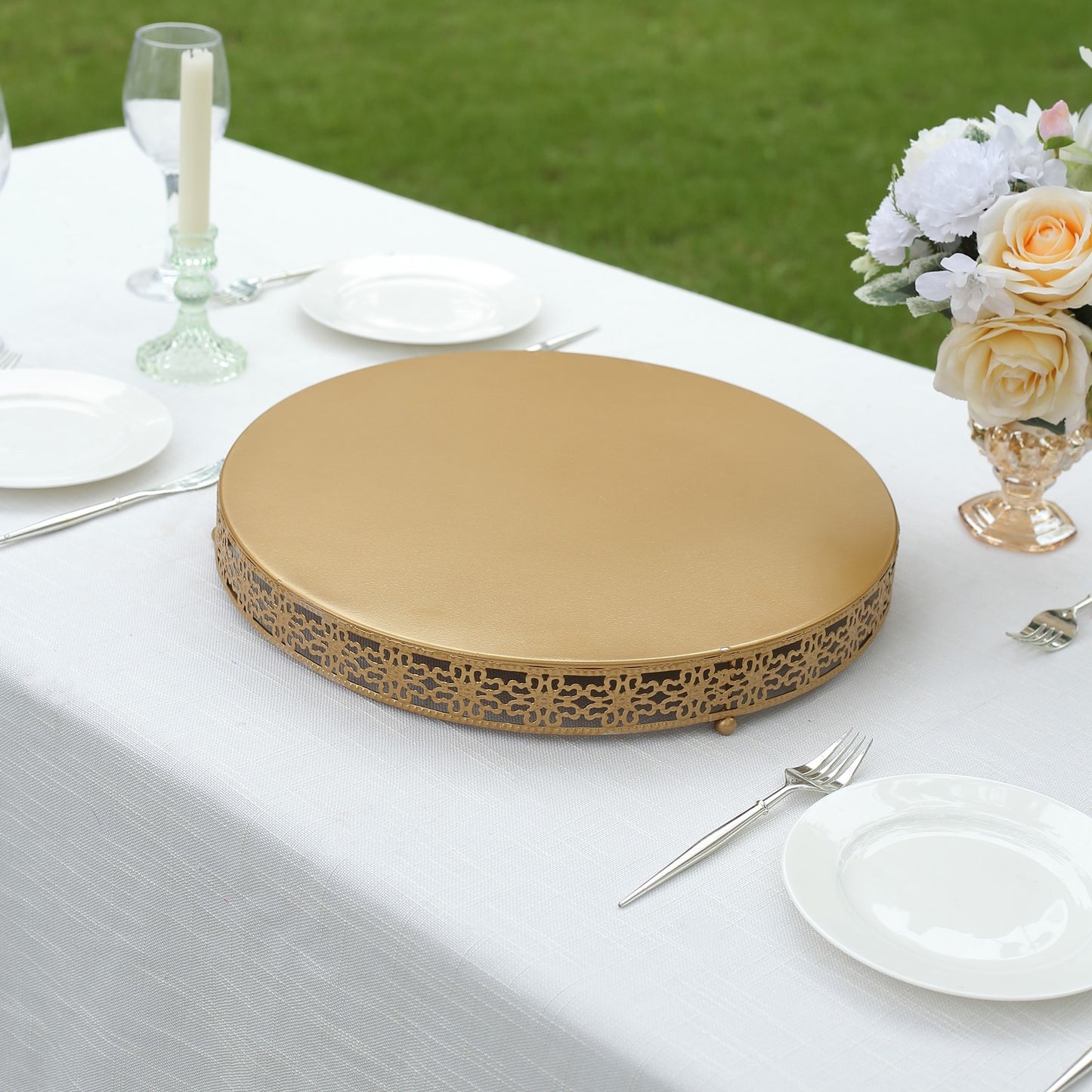 Gold round pedestal cupcake display stand on a table.