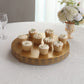 Gold metal fleur de lis cupcake display stand with desserts on a round pedestal.