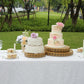 Gold metal Fleur De Lis cupcake display stand on a dessert table.