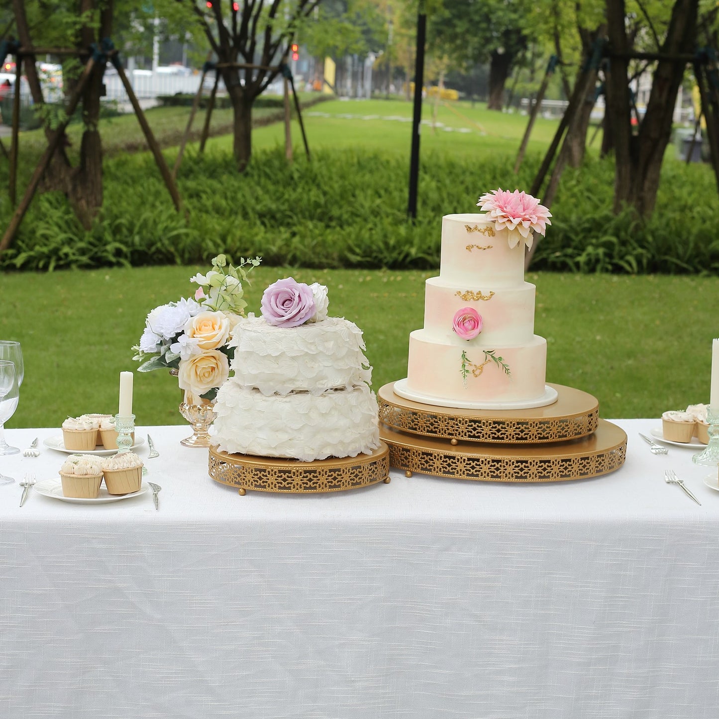 Gold metal Fleur De Lis cupcake display stand on a dessert table.