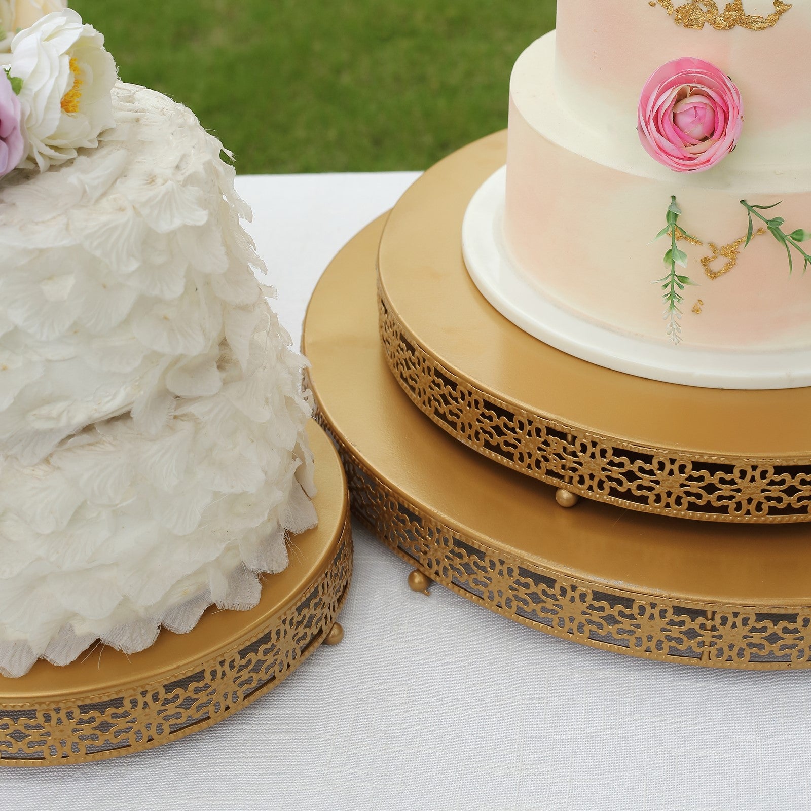 Gold metal fleur de lis cupcake stand with round pedestal for dessert display.
