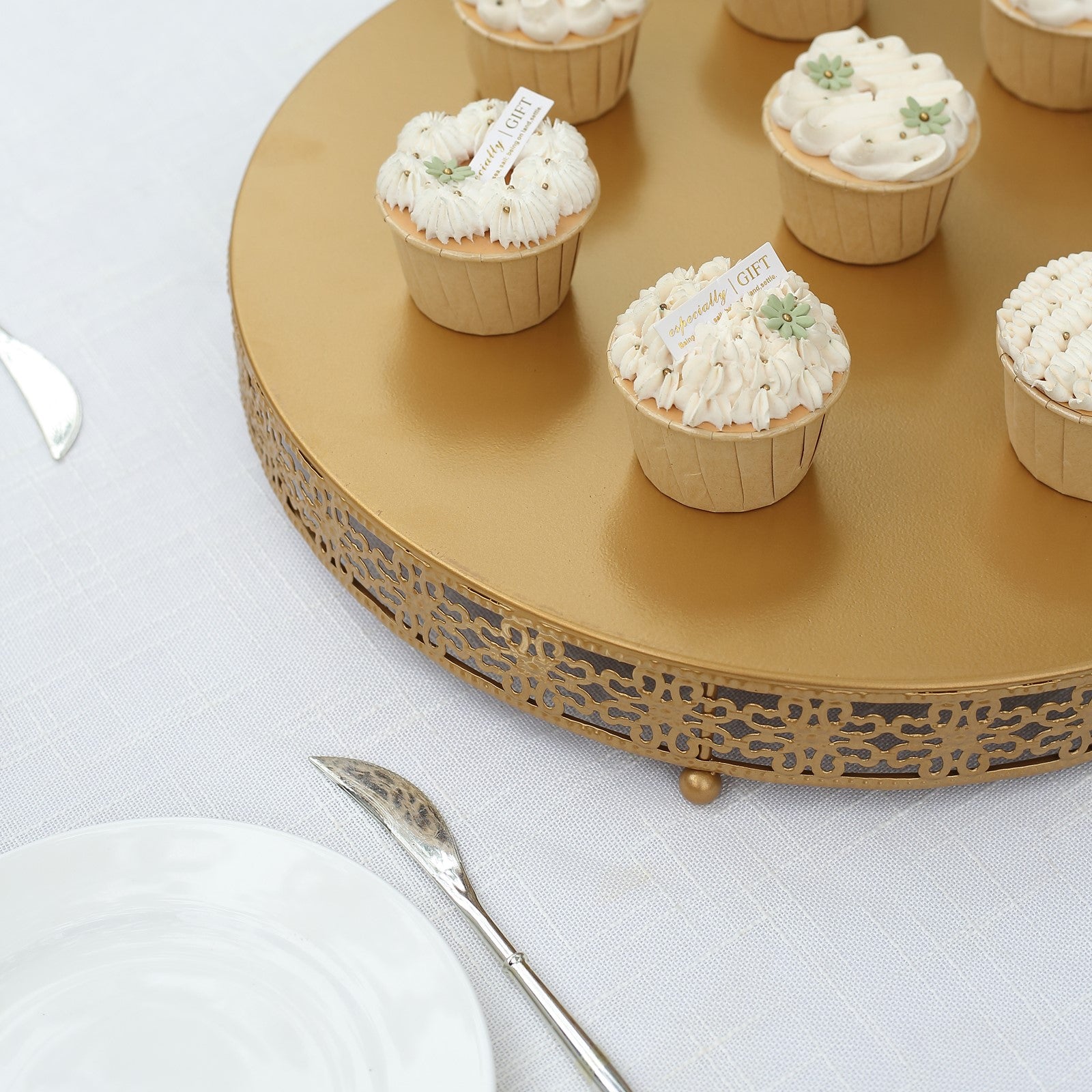 Gold metal cupcake dessert display stand with floral design, featuring decorated cupcakes.