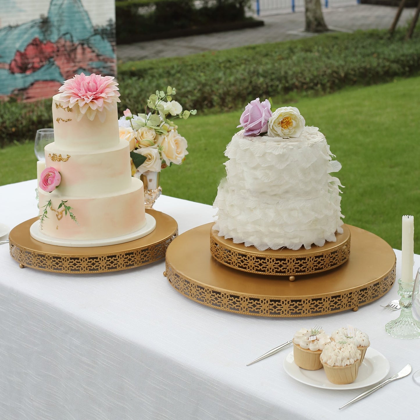 Gold metal fleur de lis cupcake stand with round pedestal design.