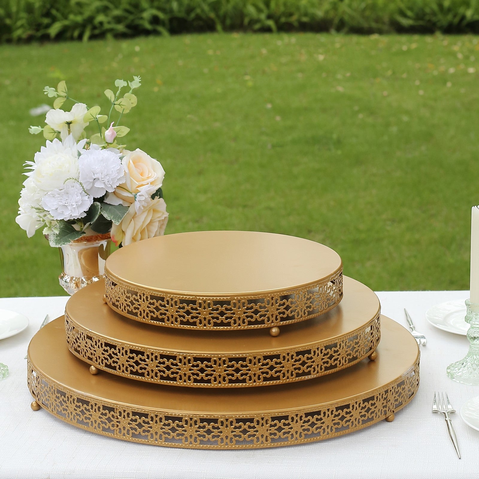 Gold metal fleur de lis cupcake display stand on a table centerpiece.