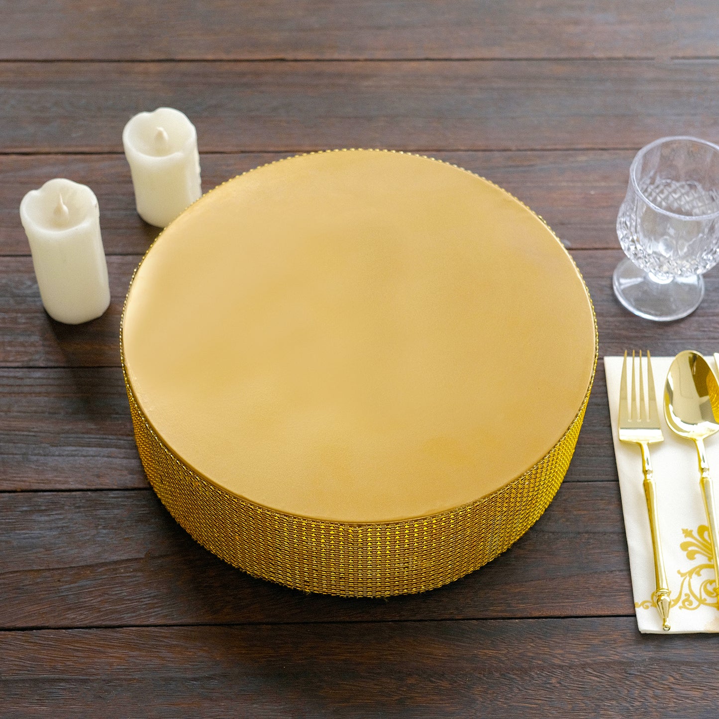 Gold round metal pedestal cake stand with rhinestones.