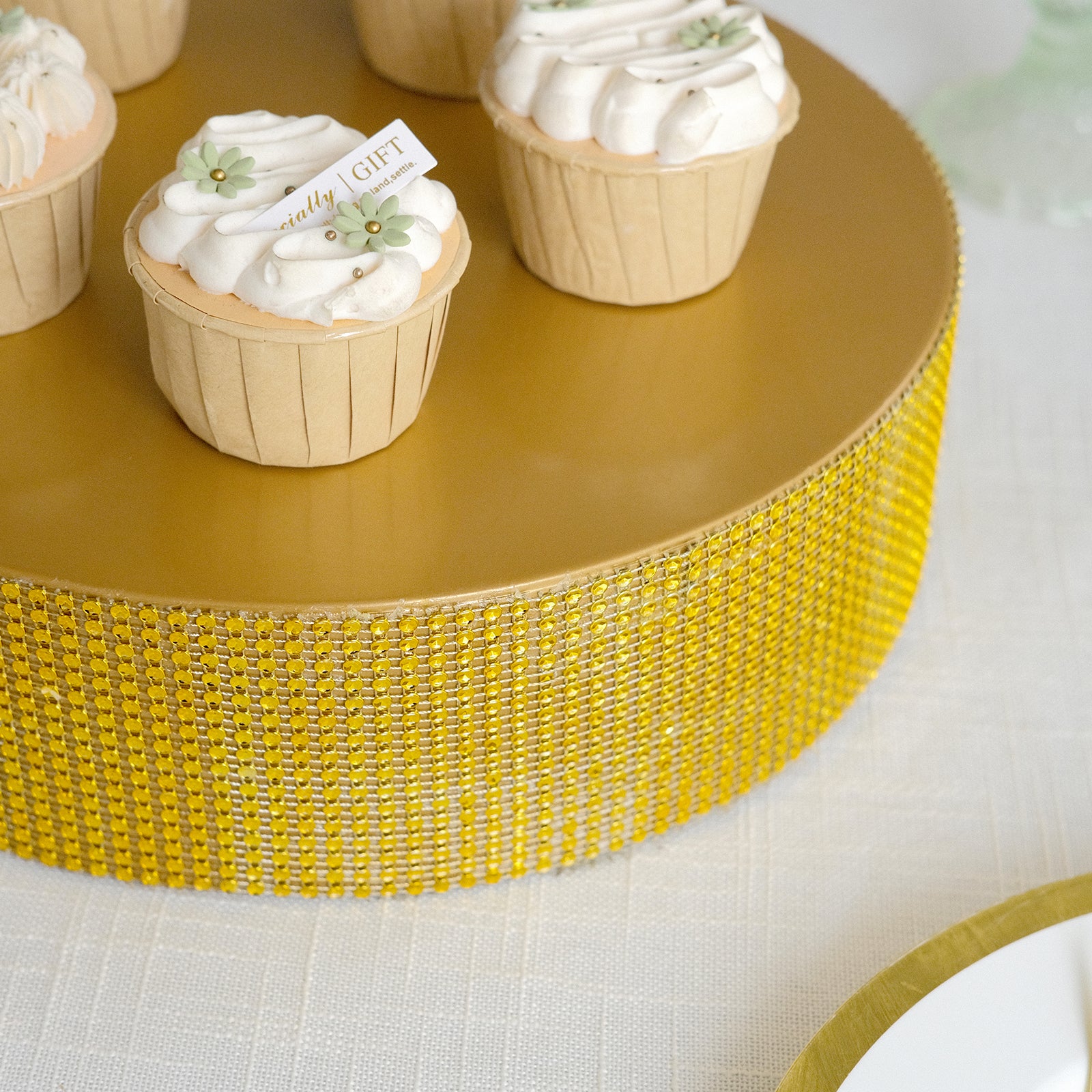 Gold round metal pedestal cake stand with cupcakes for dessert display.