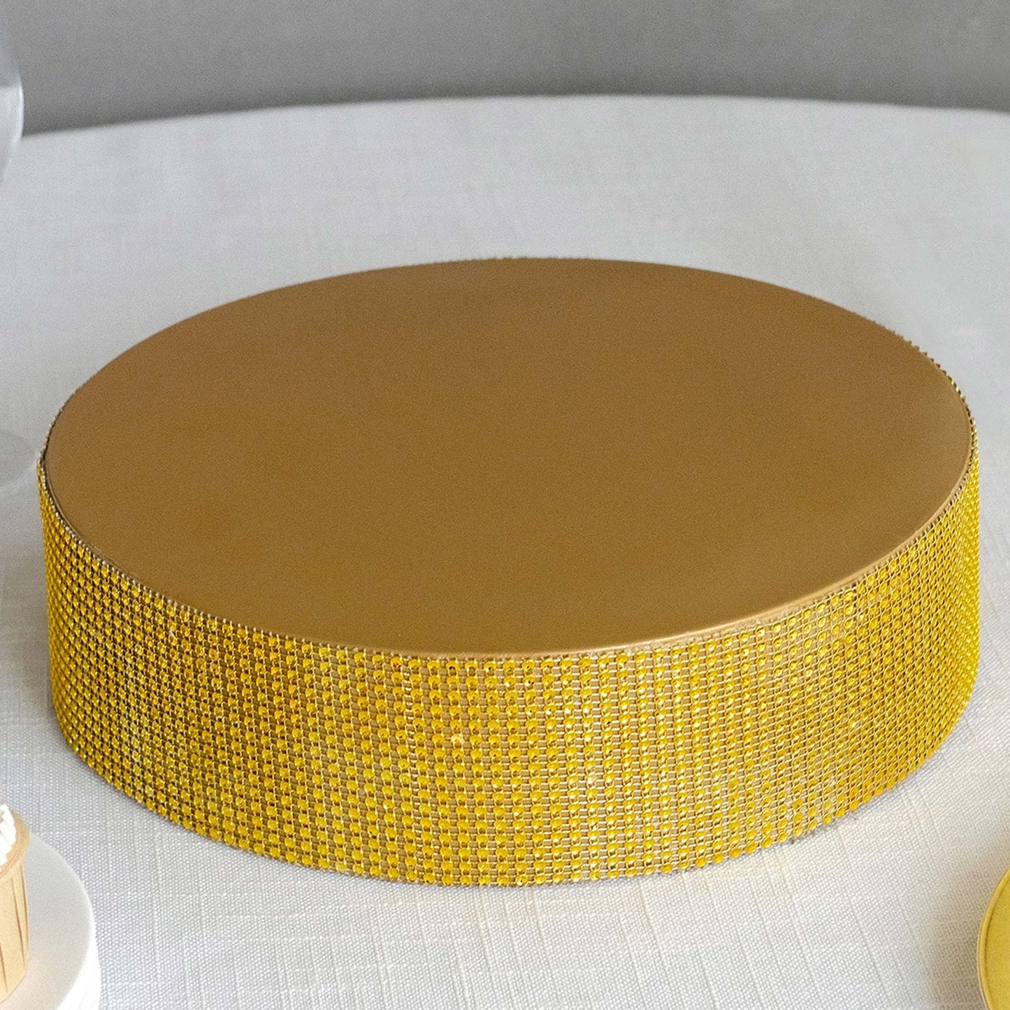 Gold rhinestone round metal cake stand, perfect for dessert table displays.