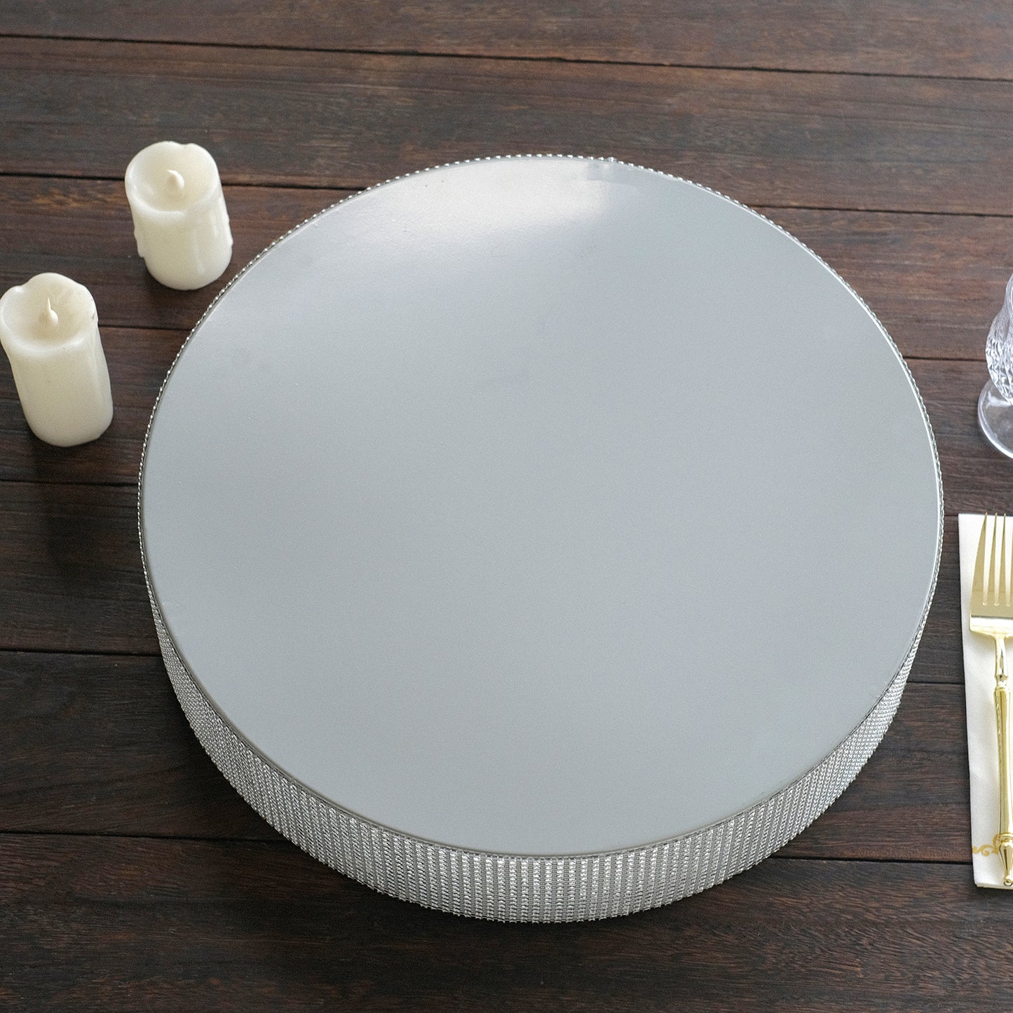 Silver round metal pedestal cake stand with rhinestones.
