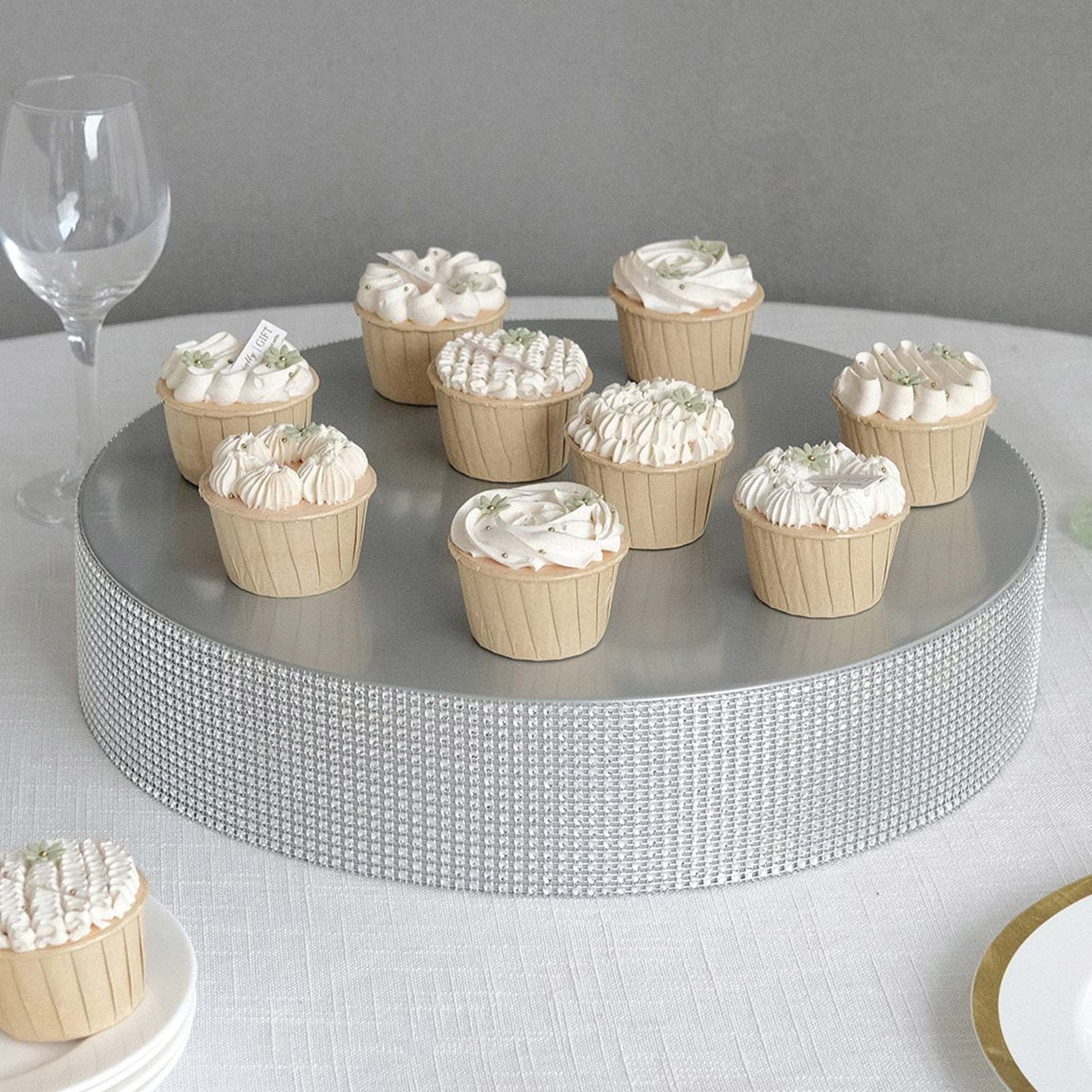 Silver round metal pedestal cake stand with cupcakes, perfect for dessert displays.
