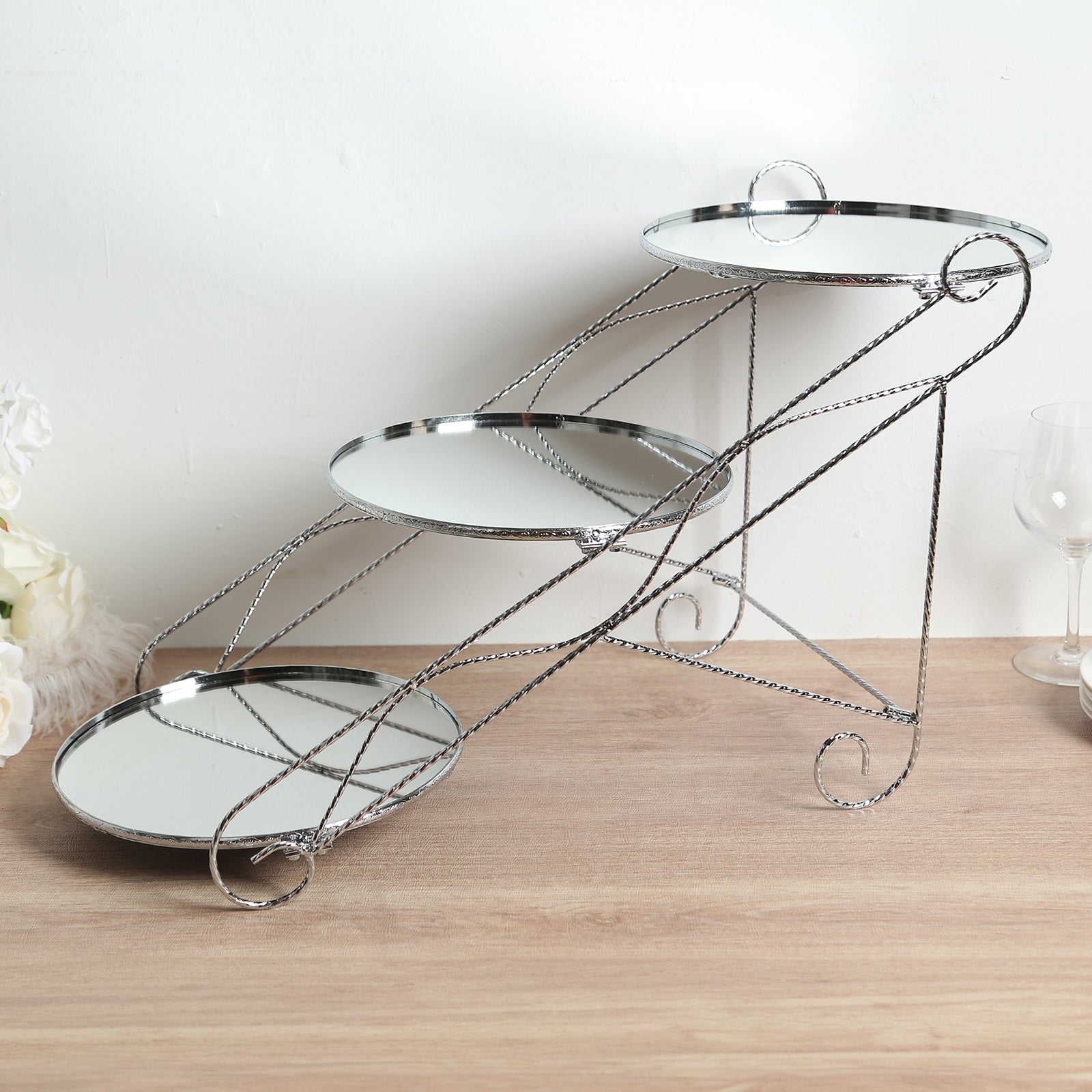 Silver 3-tier metal cupcake stand with mirror trays for desserts.