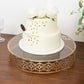Gold ornate cake stand with glass top, perfect for dessert display.