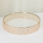 Gold ornate cake stand with glass top for elegant dessert display.