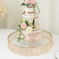 Gold metal cake stand with glass top, ornate design, perfect for dessert display.