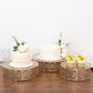 Gold ornate cake stands with glass tops for desserts, stackable for events.