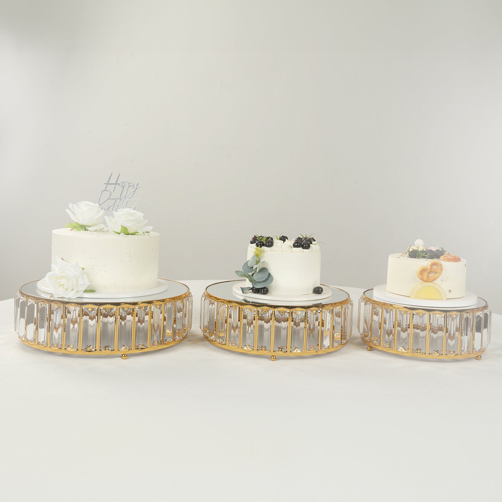 Gold metal crystal pendant cake stands with mirror tops, stackable dessert display trays.