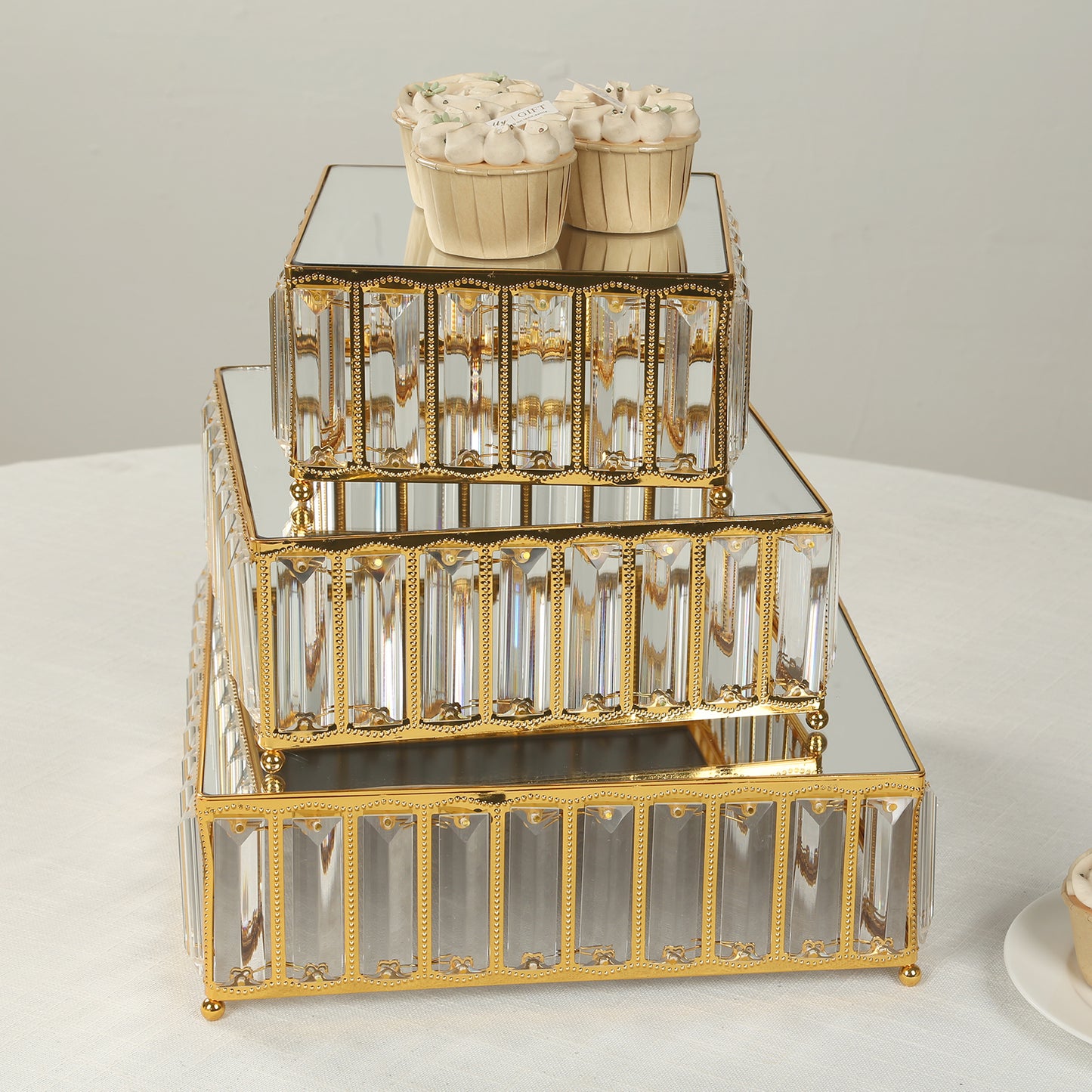 Gold metal crystal pendant cake stands with mirror tops, stackable dessert display trays.
