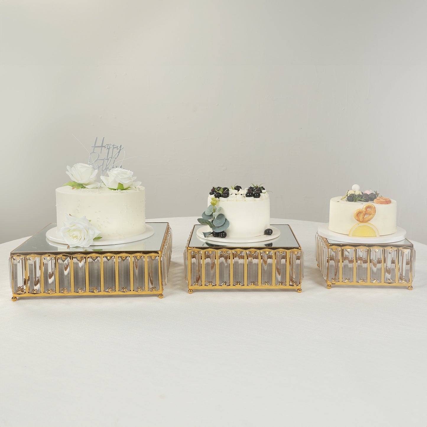 Gold metal crystal pendant cake stands with mirror tops, stackable dessert display trays.