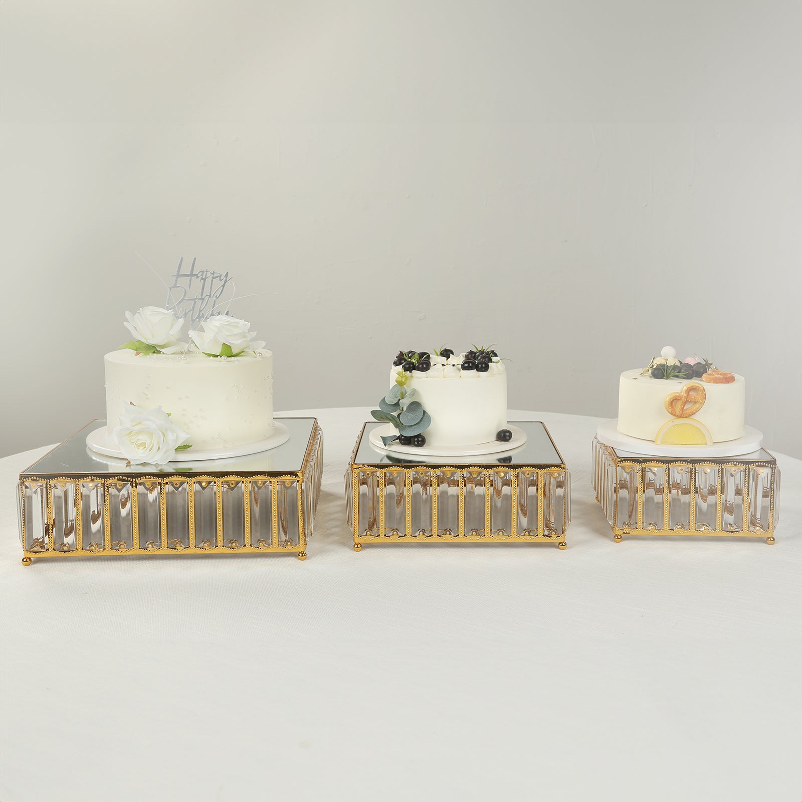 Gold metal crystal pendant cake stands with mirror tops, stackable dessert display trays.