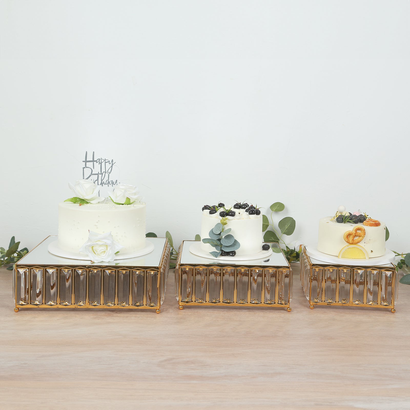 Gold metal crystal pendant cake stands with mirror tops, stackable dessert display trays.